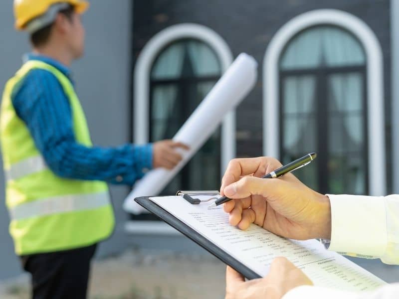 Professionals reviewing survey documents and plans during a commercial real estate transaction and ALTA survey process.