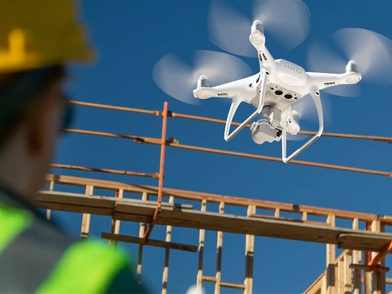 Survey drone collecting aerial site data above a construction project to support mapping, planning, and land surveying activities.