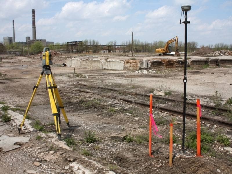 Aerial view of survey stakes among old foundations and pavement at a brownfield redevelopment site.